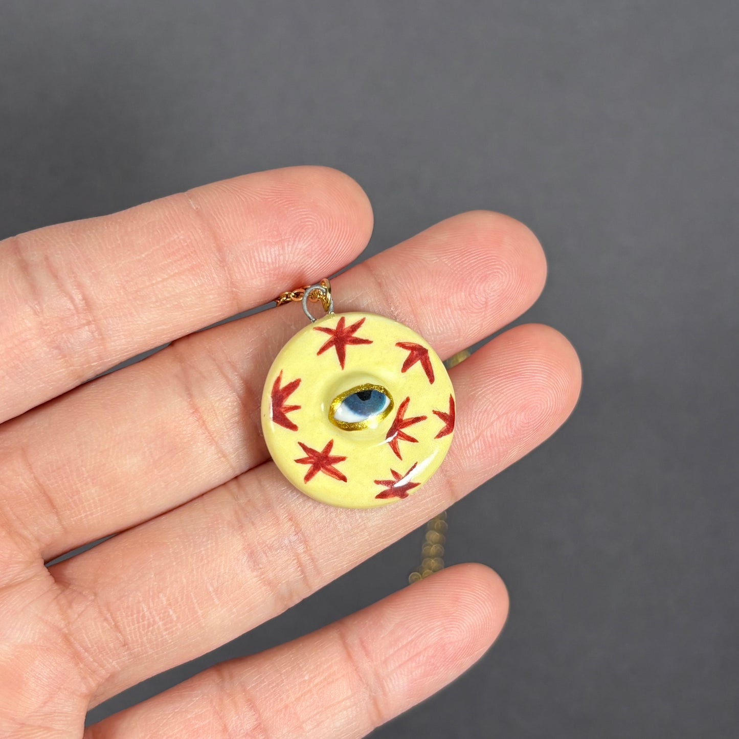 Handmade ceramic necklace, Evil Eye ceramic pendant series, natural boho style, rustic nature-inspired design.